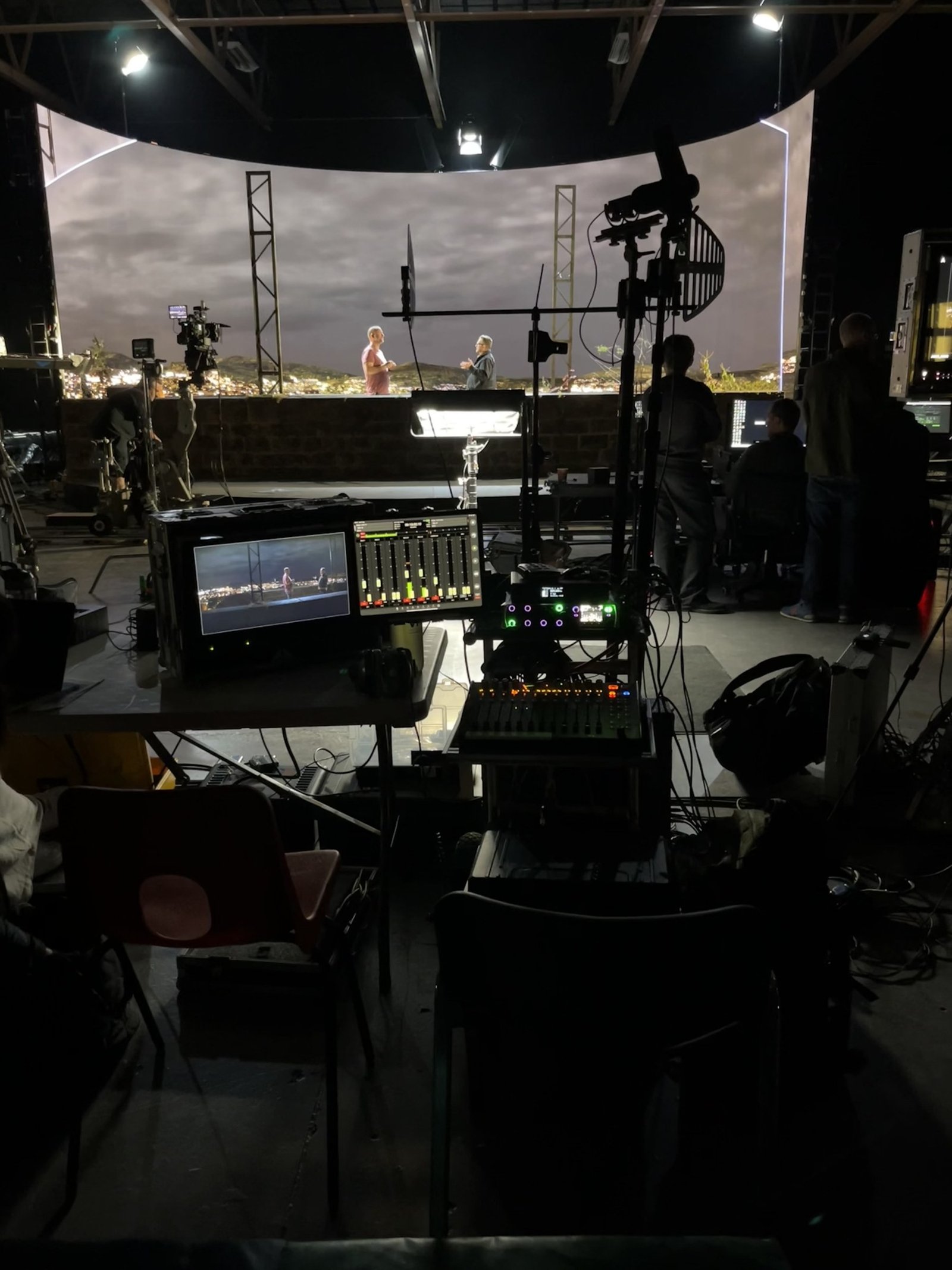 Sound cart and multitrack mixer on a virtual production stage, LED backdrop behind.